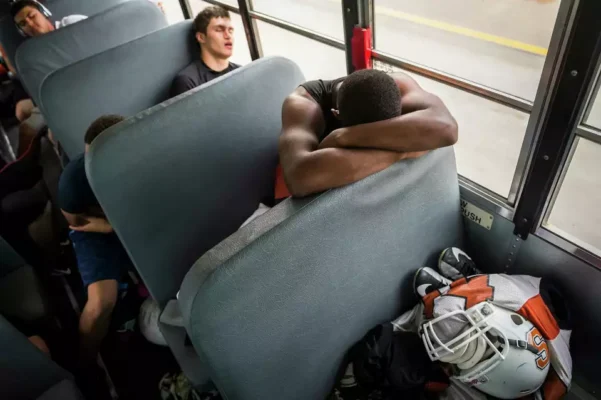 High school sports team boarding charter bus in Northeast Ohio for safe travel to games and tournaments